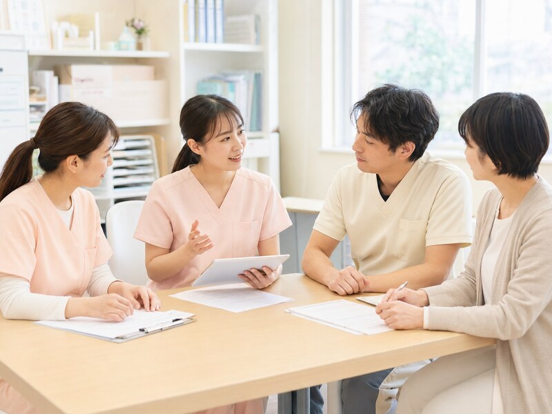 スタッフ同士が事業所内で相談・報告し合っている様子